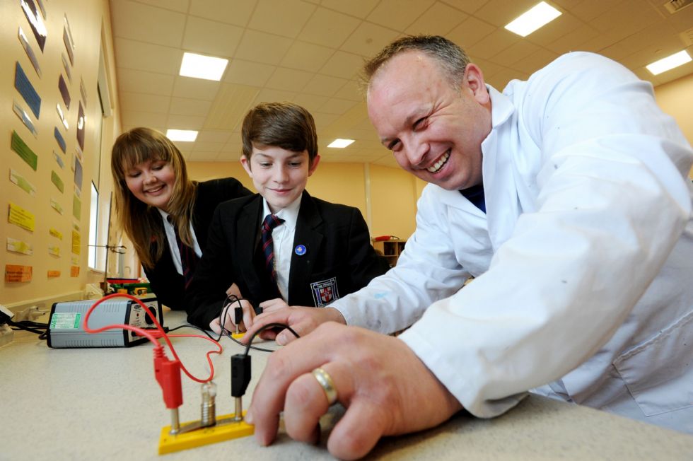 Science teacher with two secondary pupils
