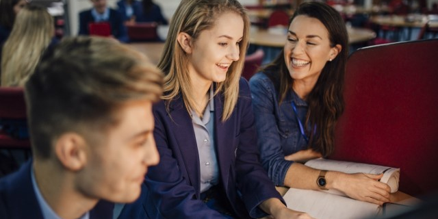 Image of a teacher with two students 